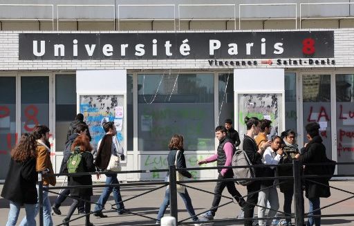 1200x768_students-stand-outside-the-paris-8-saint-denis-university-due-to-a-blockade-of-the-building-on-april-6-2018-in-saint-denis-to-protest-against-a-project-of-selection-for-the-admission-in-french-universities-students-at-three-universities-in-paris-toulouse-and-lyon-blocked-faculty-buildings-in-protest-at-french-president-macron-s-plans-to-make-university-entry-more-selective-joining-a-slew-of-nationwide-sit-ins-that-have-disrupted-classes-for-weeks-photo-by-ludovic-marin-afp